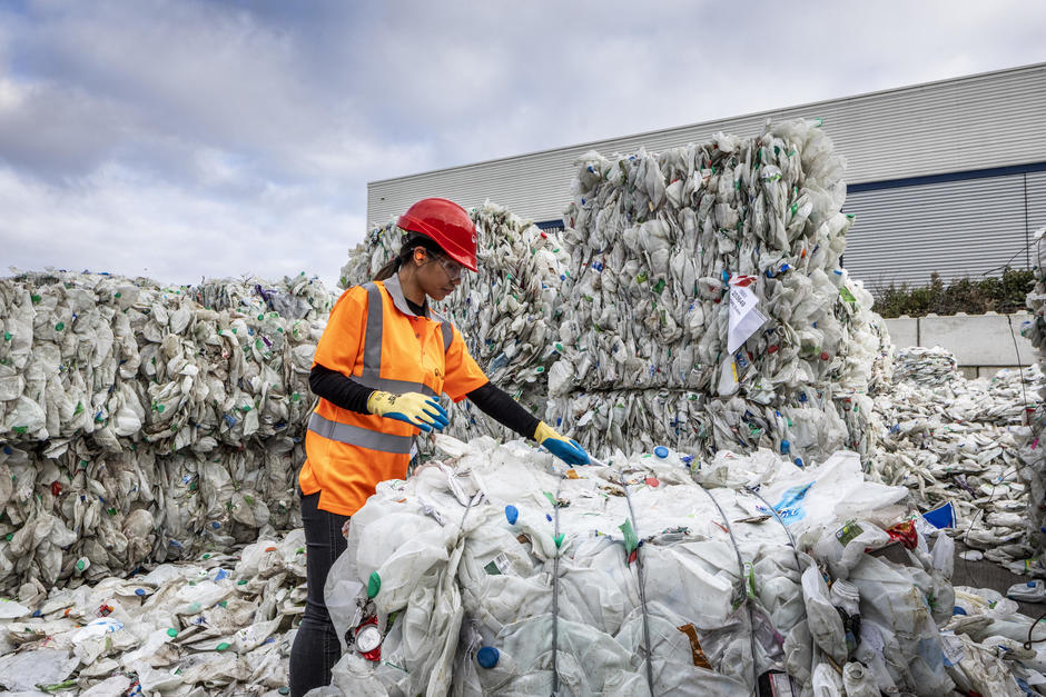 Worker recycling plastics