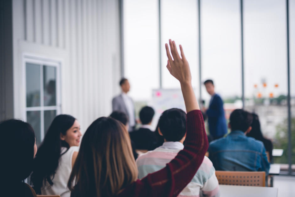 Person raising their hand to ask a question