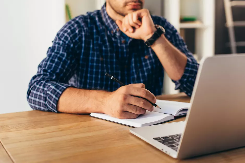 A person on their laptop watching a webinar