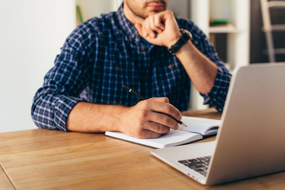 A person on their laptop watching a webinar