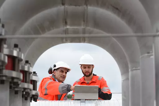industrial water site workers in hi vis