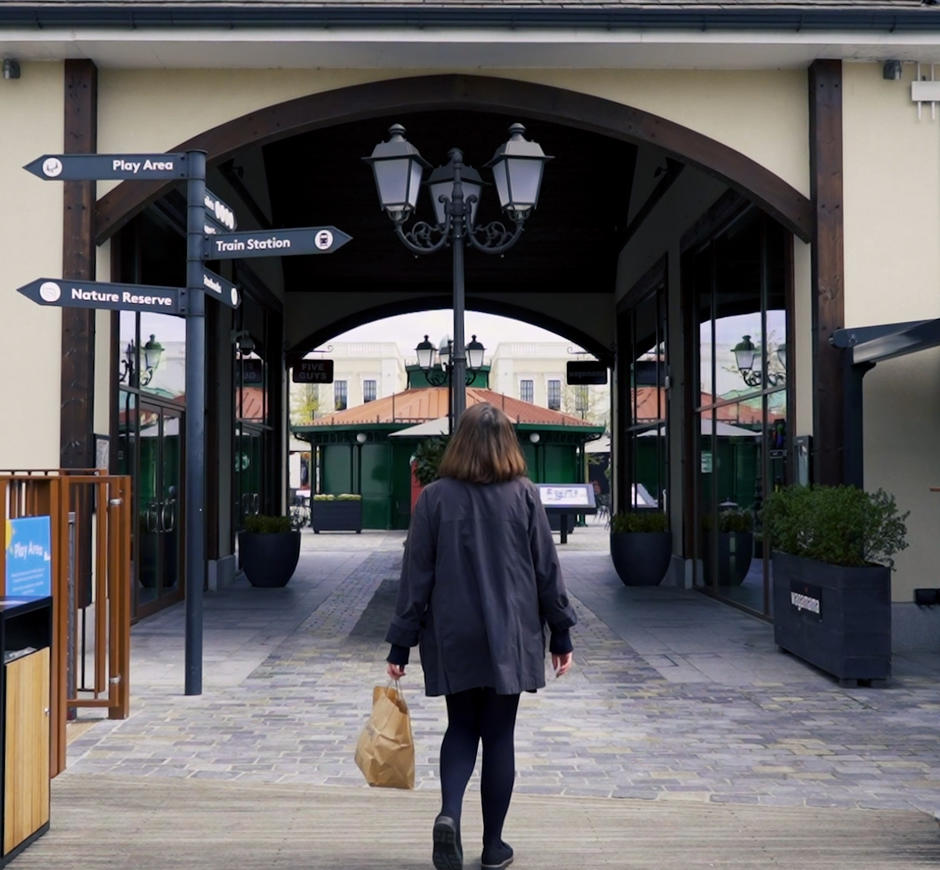 A woman walks into the McArthurGlen designer outlet.
