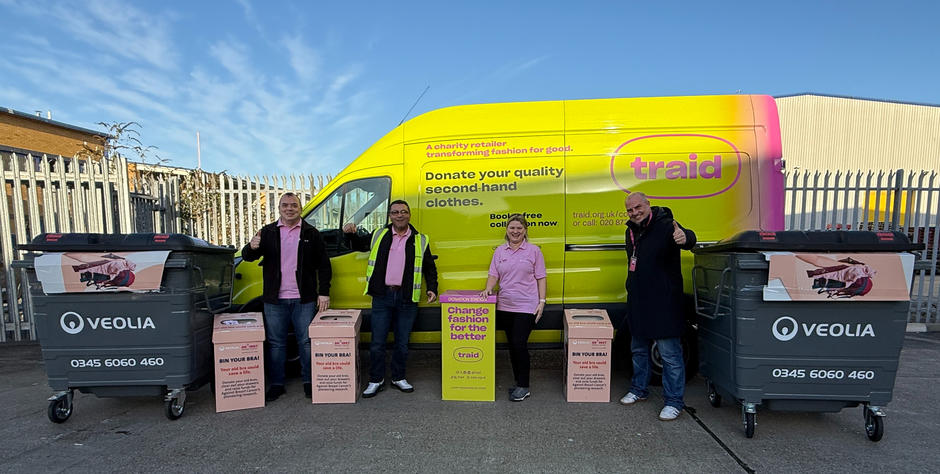 Veolia and Traid representatives stand in front of a Traid van alongside Against Breast Cancer collection boxes.