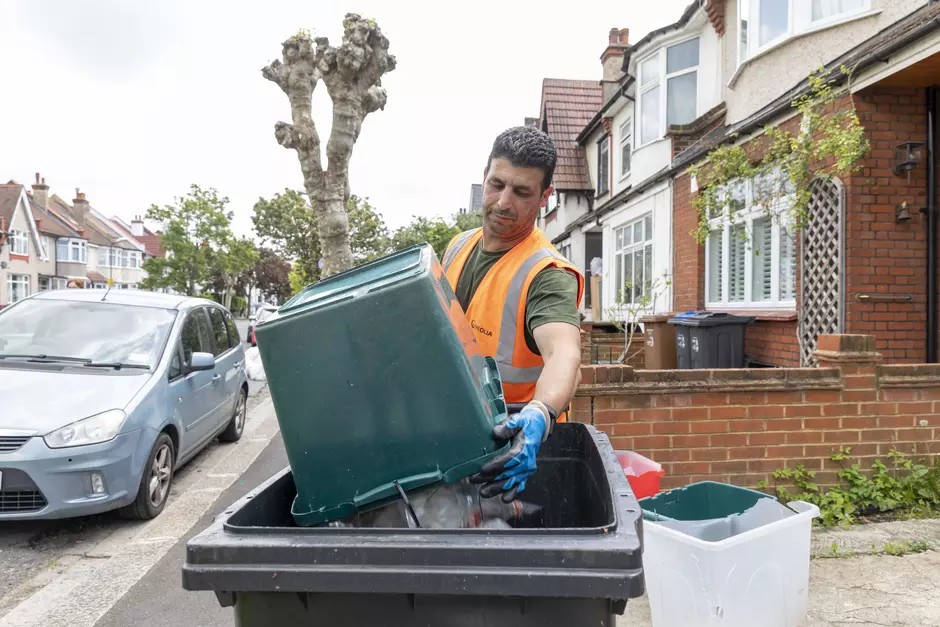 Veolia staff emptying bin
