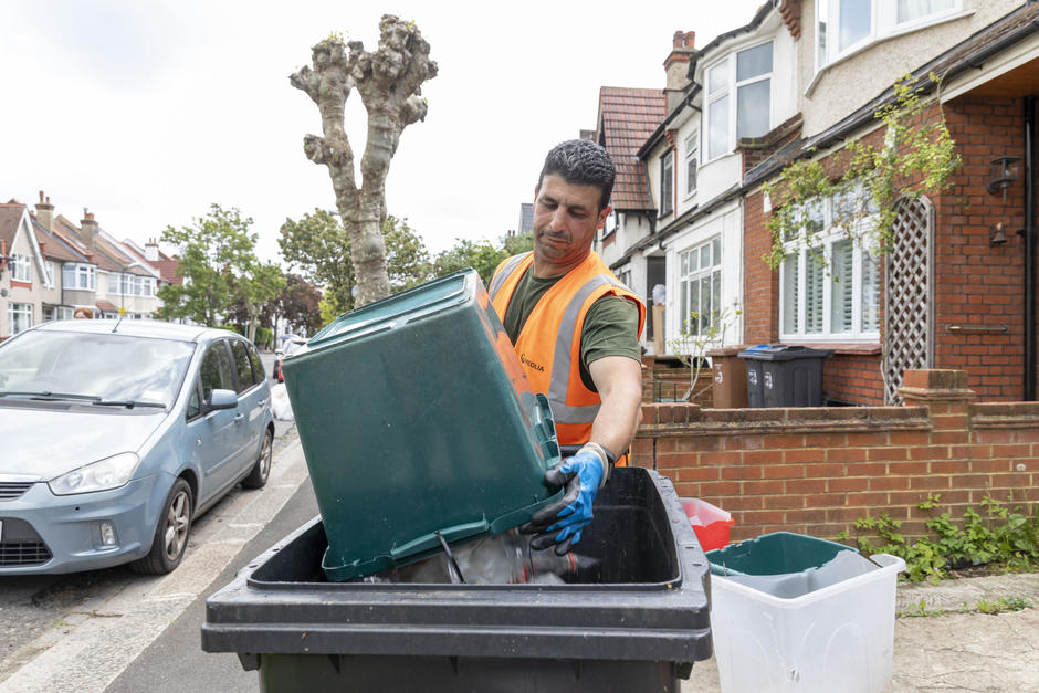Veolia staff emptying bin