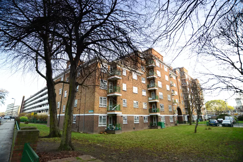 Photo taken from the pavement outside a large block of flats.
