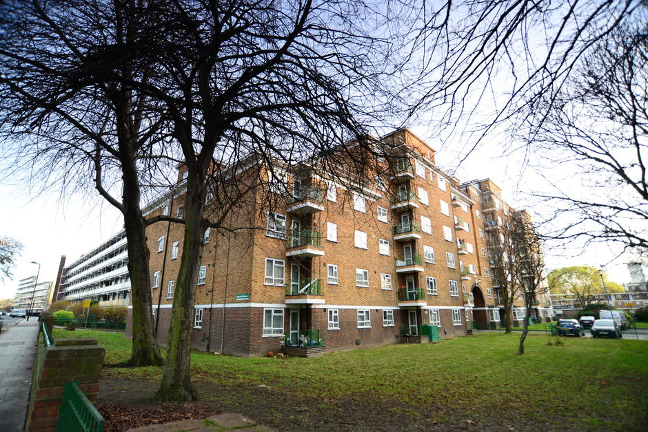 Photo taken from the pavement outside a large block of flats.