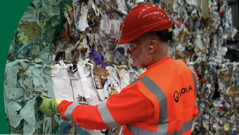 Veolia worker inspecting paper and cardboard waste 