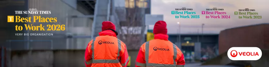 Two Veolia workers walking towards a facility with text 'The Sunday Times Best Places to Work 2026'