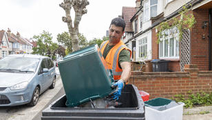 Veolia staff emptying bin